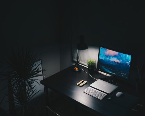Clean and ergonomic desk setup with monitor at eye level and proper ambient lighting